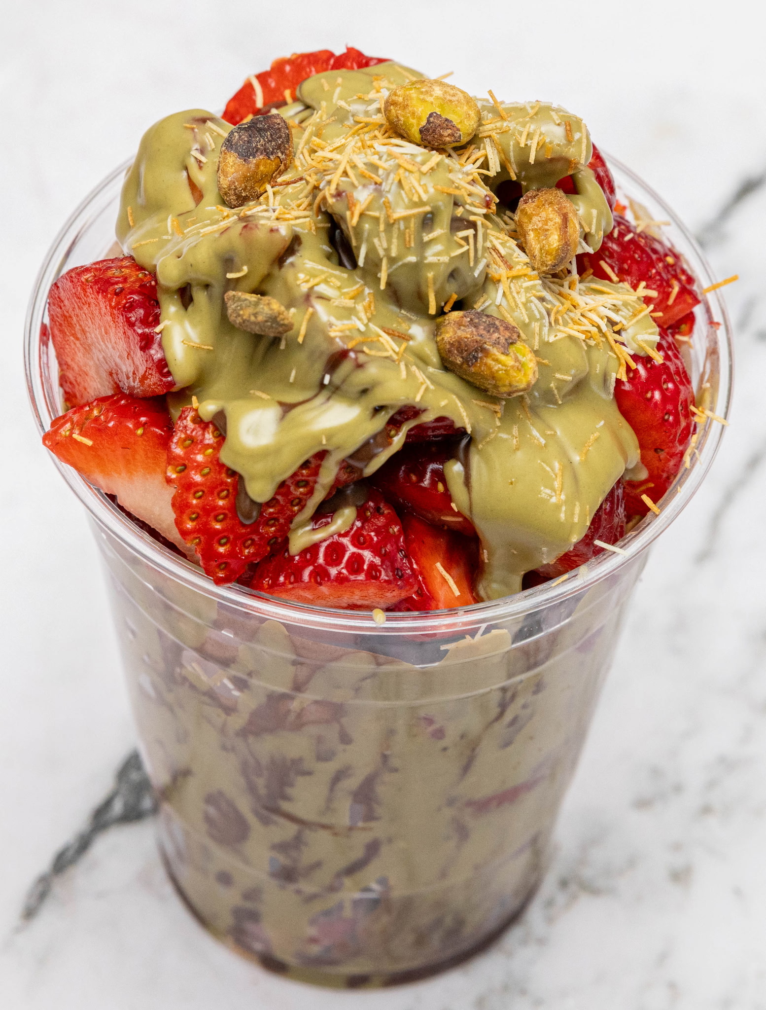 Strawberry cup with pistachio cream sauce