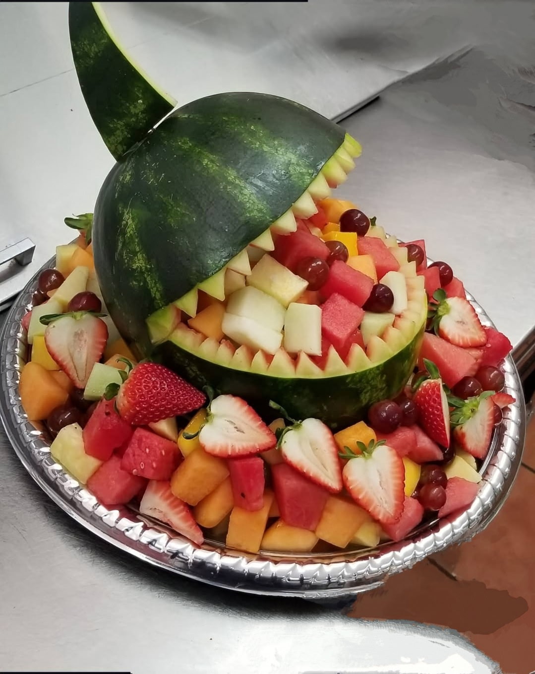 Shark watermelon carving with fruit display